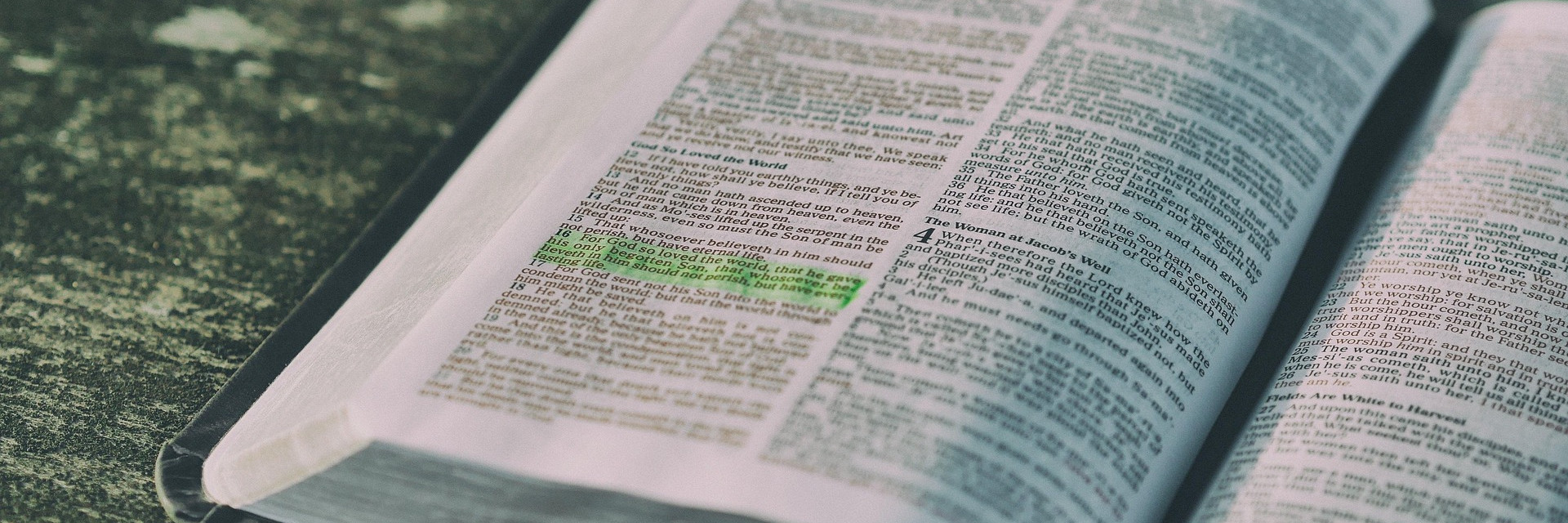 Open Bible with highlighted text, focusing on John 3:16, discussing belief and eternal life through Jesus.
