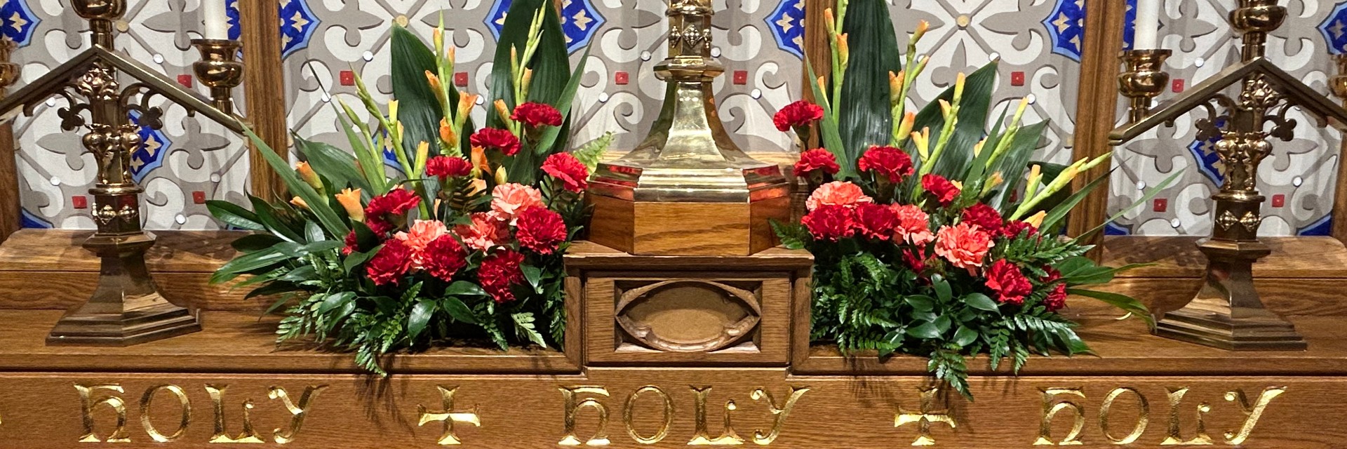 Altar flowers on reredos Pentecost